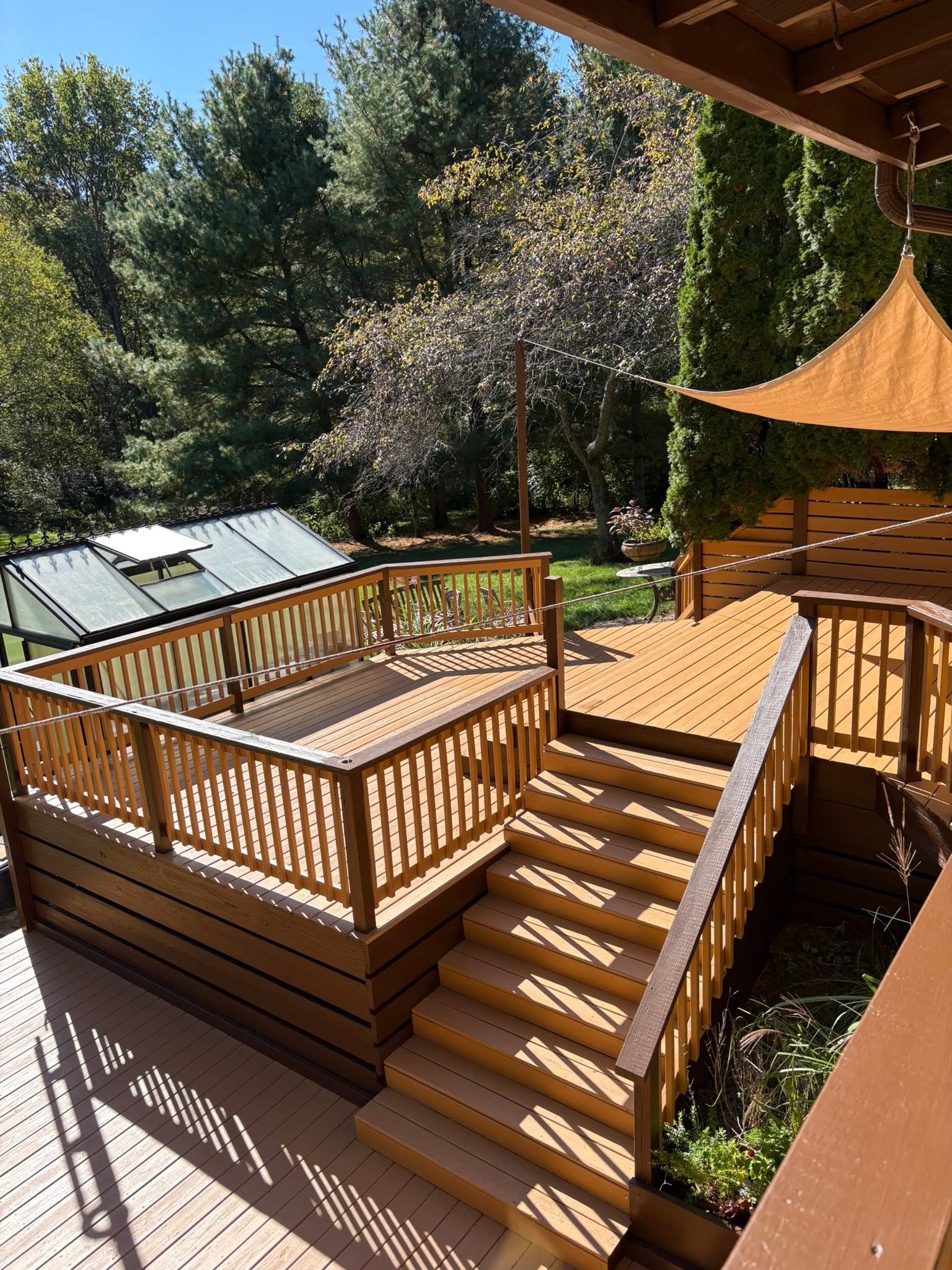 Warmly stained multi-level backyard deck