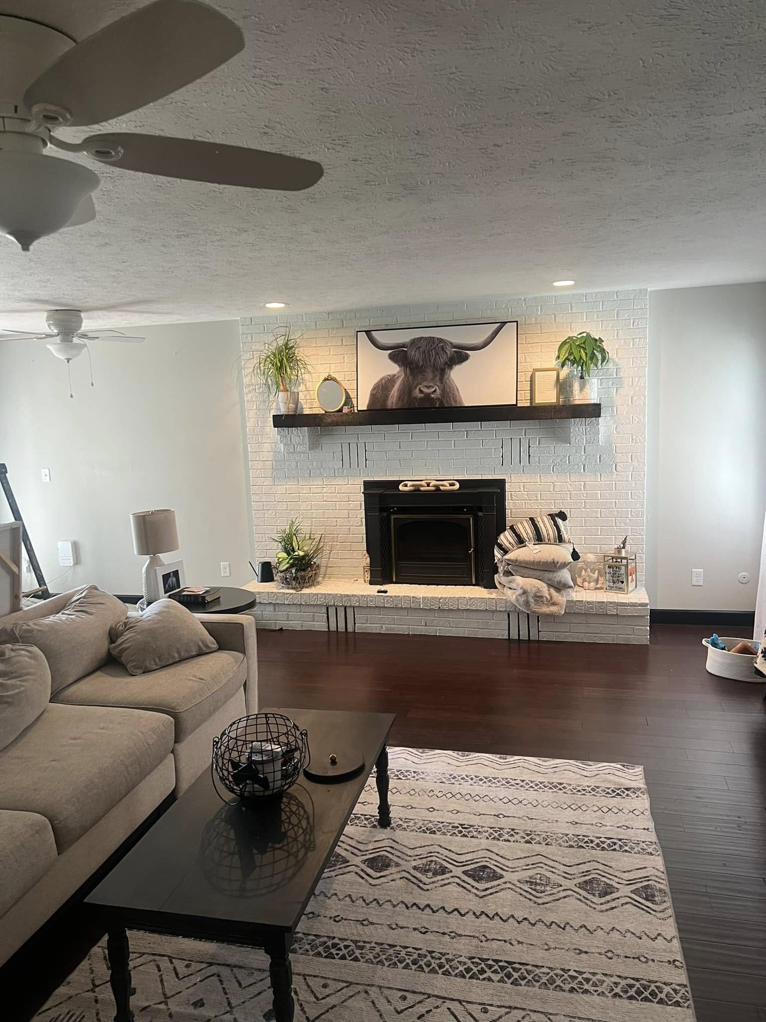 Freshly painted living room with a bright white fireplace