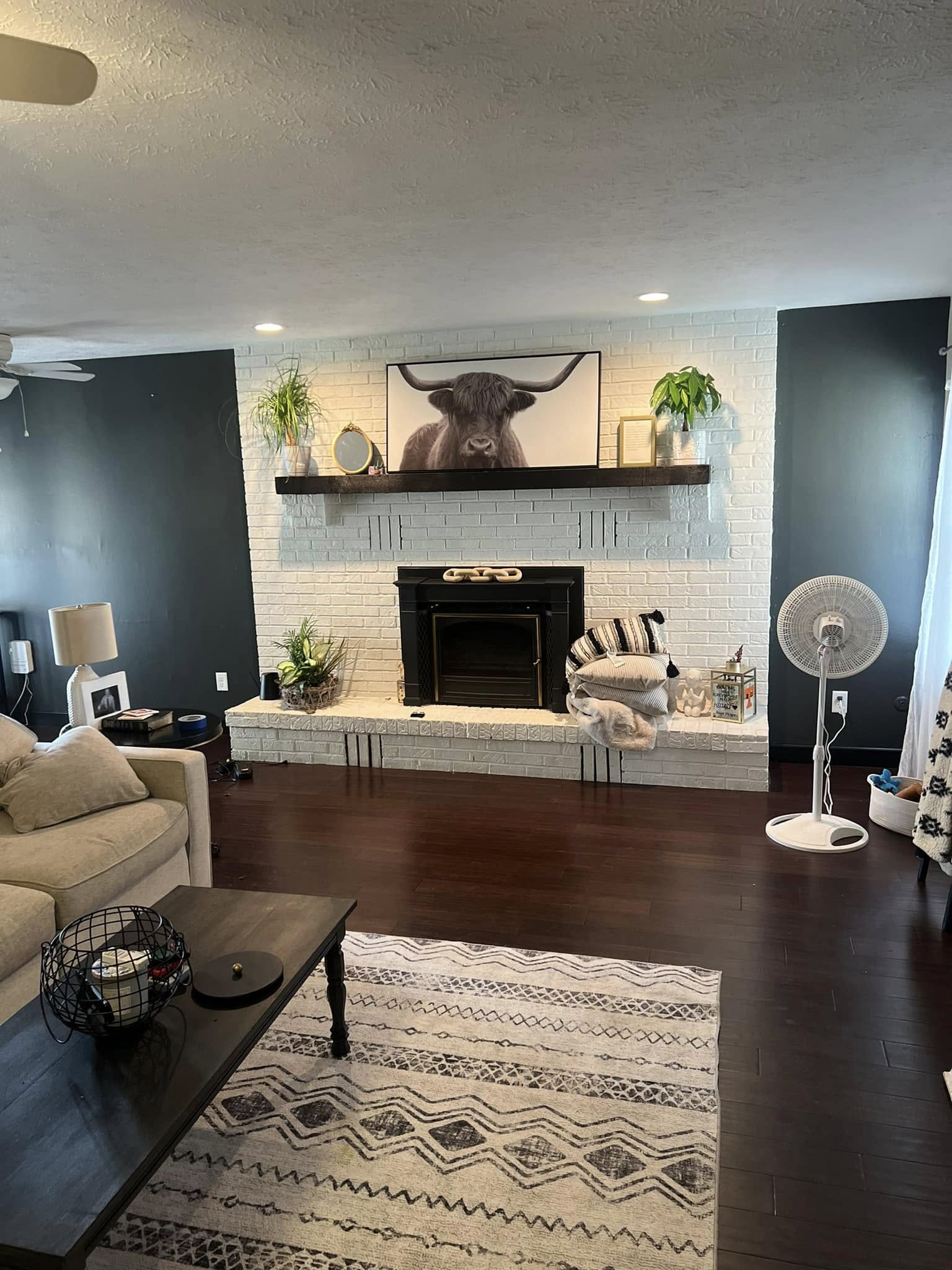 Detailed painted fireplace wall with dark accent walls